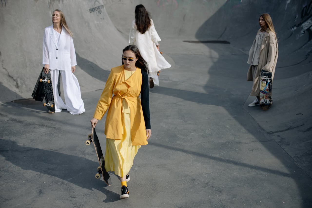 services-06 Stylish women with skateboards in a skate park, showcasing modern fashion trends.